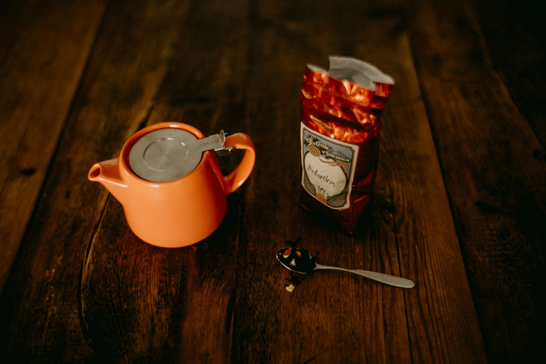 a tea pot and a tea bag on a wooden table