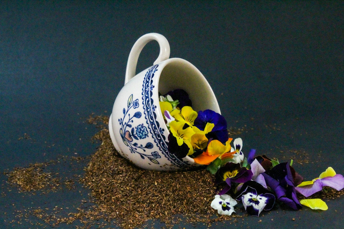 a tea cup with flowers in it