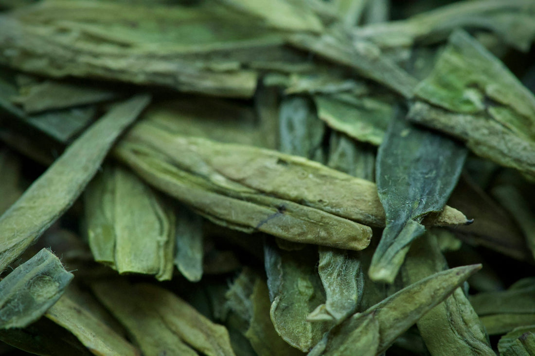 Dried green tea leaves in a close-up view