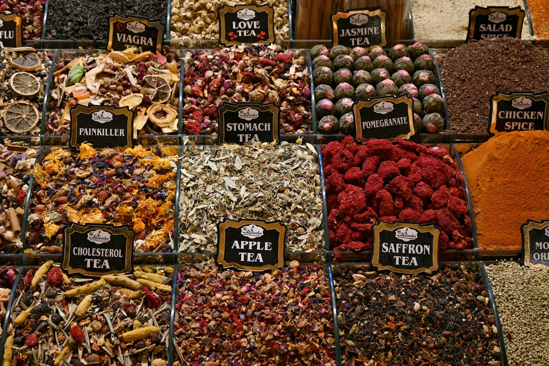 A vibrant display of various dried fruits, teas, and spices