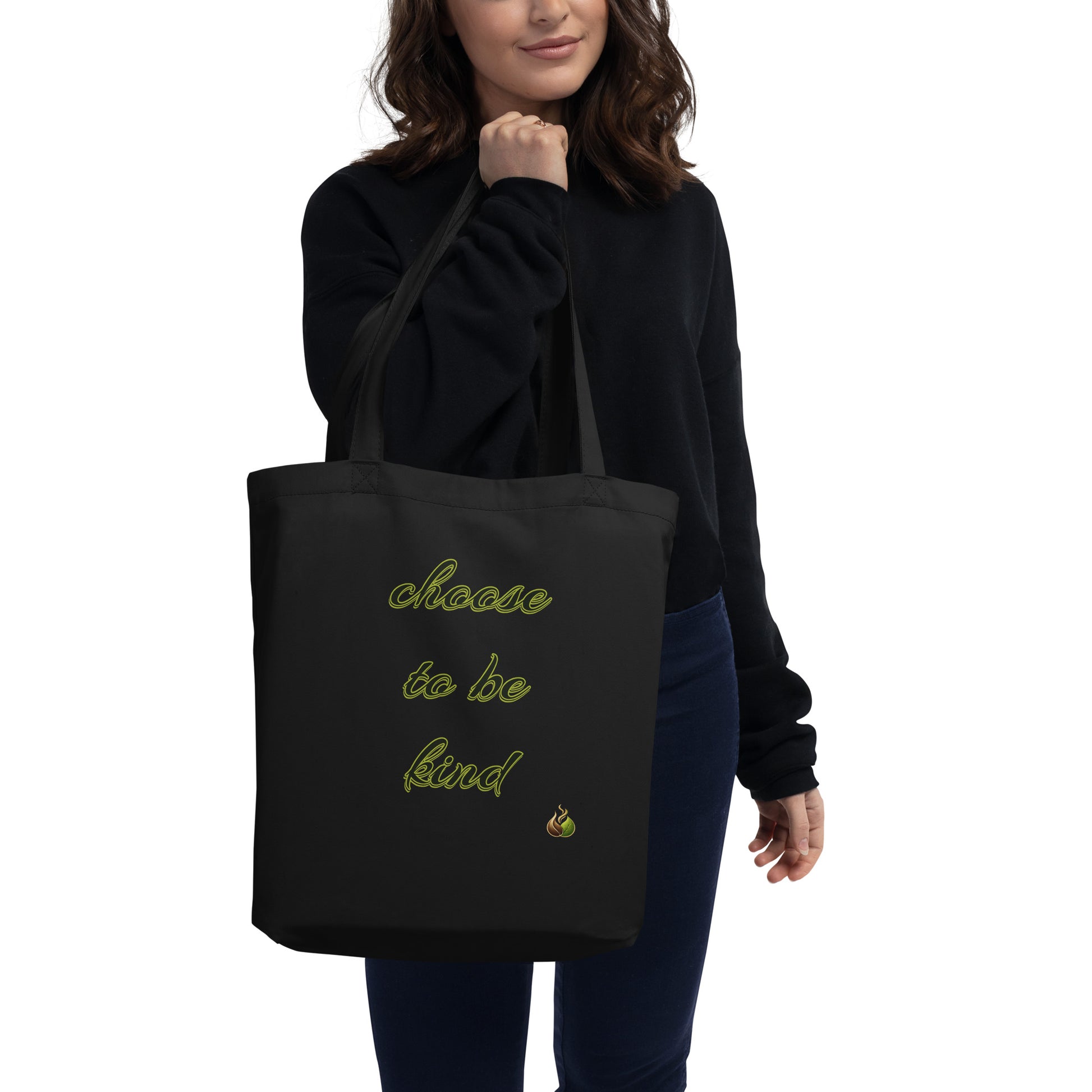 Person holding a black tote bag with a design and text on a white background