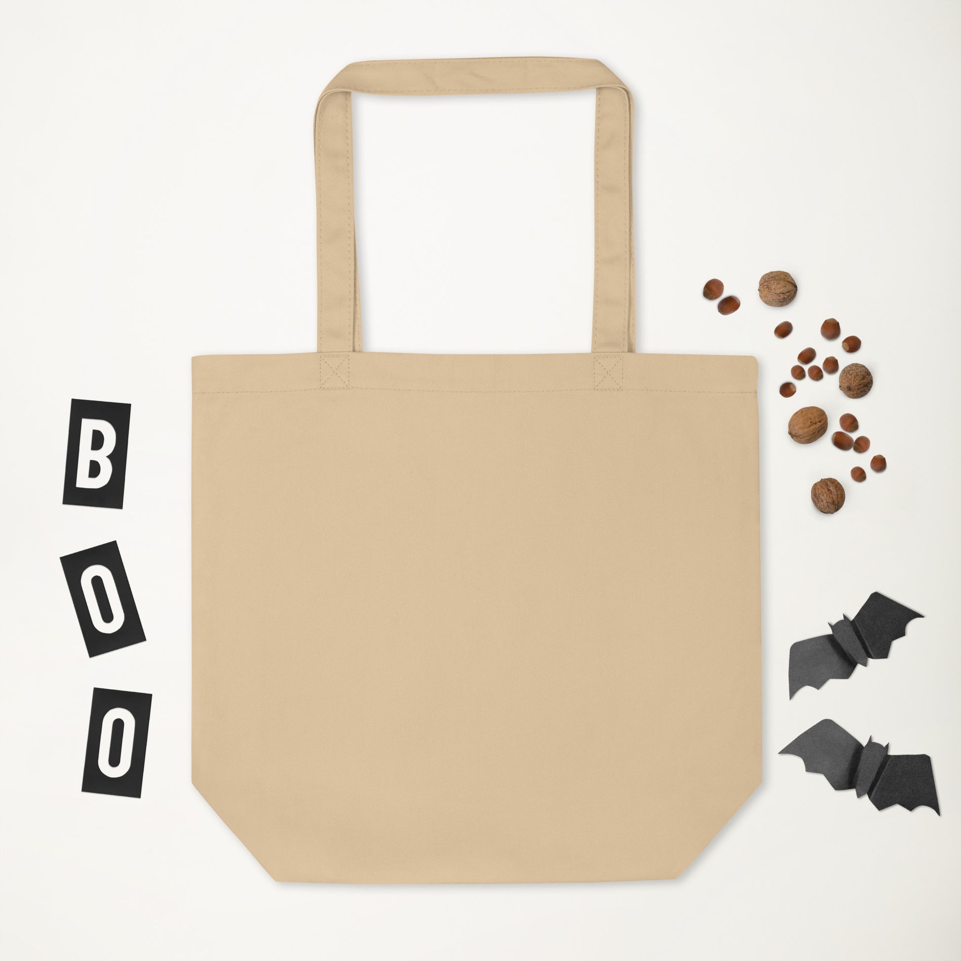 Beige tote bag with Halloween decorations on a white background