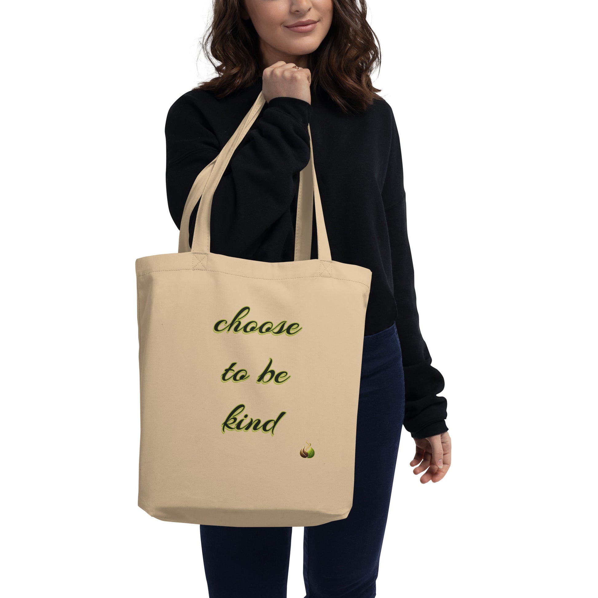 Person holding a beige tote bag with a black logo on a white background